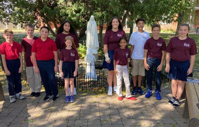 Students with statue of Mary