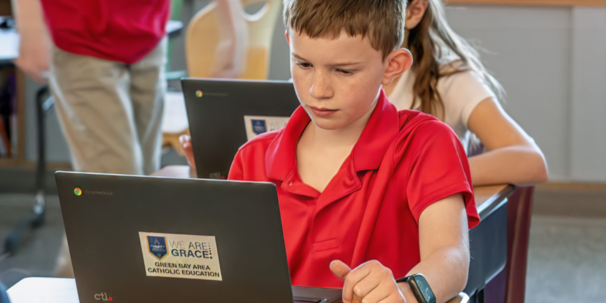 Boy on GRACE laptop in classroom